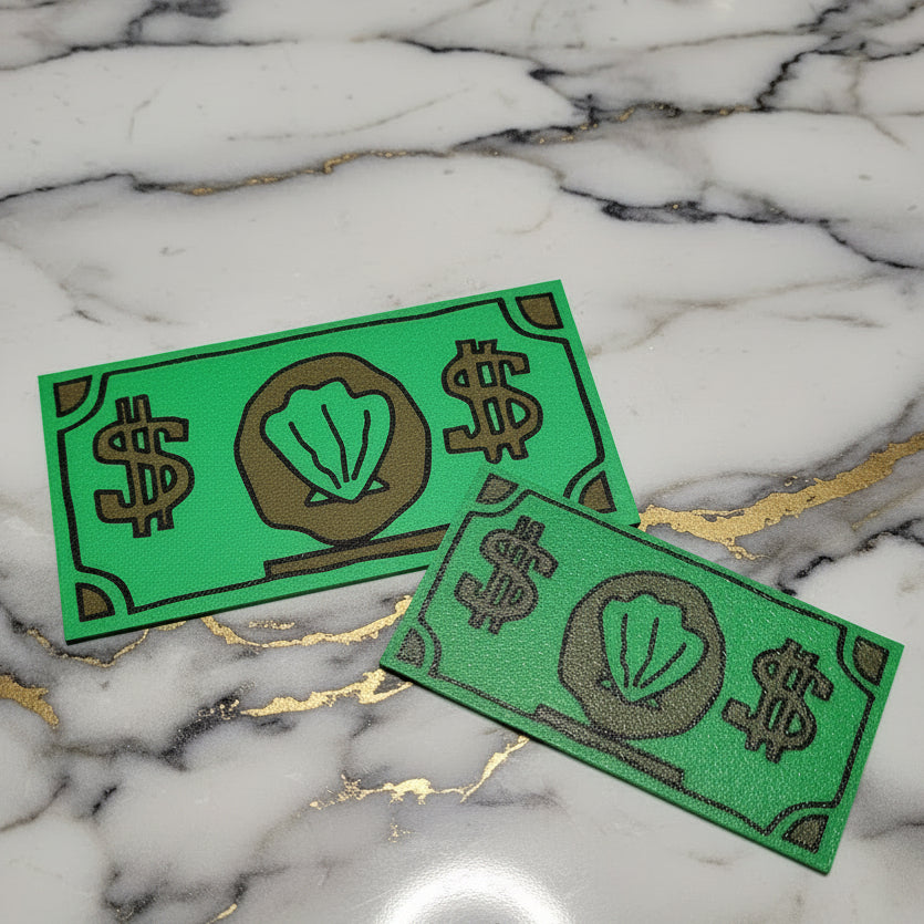 Two green rectangular plastic debit card sleeves against a marble background.