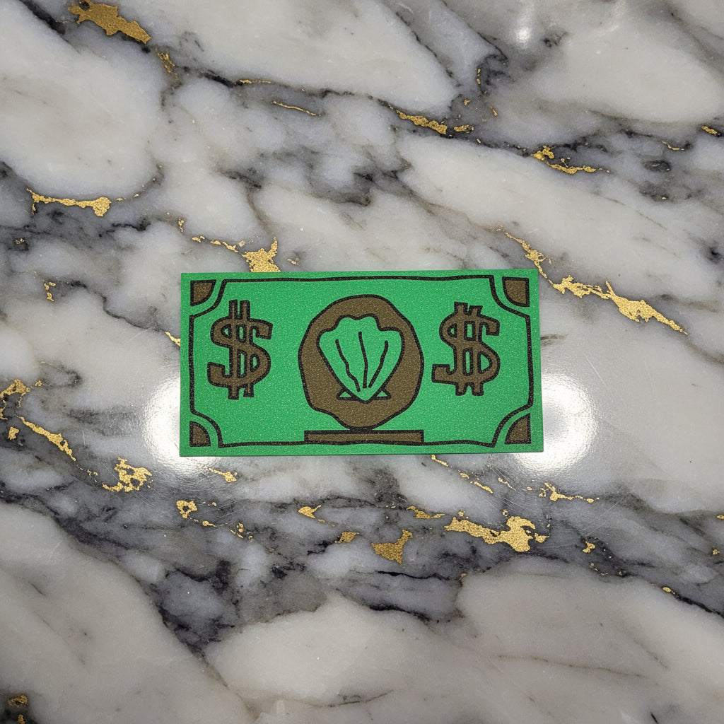 A green novelty debit card sleeve shaped like a dollar bill, featuring brown dollar sign symbols and a shell icon in the center, displayed on a marble background